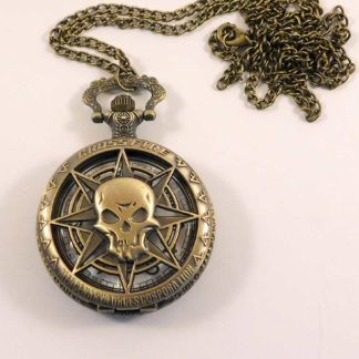 The front of the antique gold fob watch showing a star with skull motif