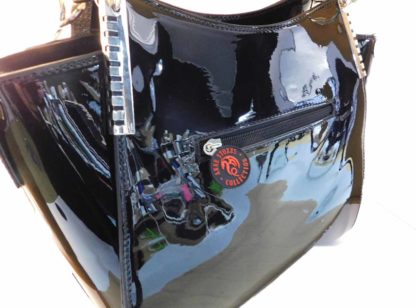 The back of the bag showing the zippered pouch and shiny black construction