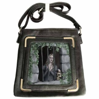 This bag has a holographic insert framed by silver detailing - a gothic woman stares out of bars with a colourful bird in reds and oranges sits on a skull