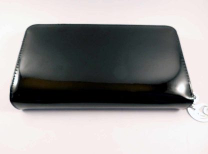 The back of the purse is sleek black shiny PVC