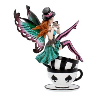 A fairy sits on two stacked tea cups - both black and white, one with stripes, one with the spades symbol around the outside