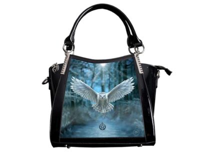 This handbag has a front panel featuring a snowy white owl flying towards you, a pentagram on a chain clasped in its claws. The owl is flying out of a blue and grey forest.