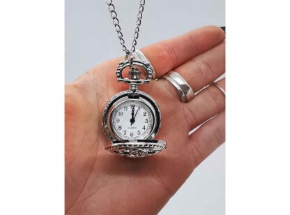 The small size of this fob watch is shown by being in a hand - its perfect for the smallest of hands!