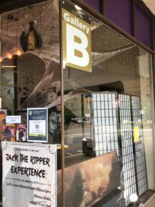 The front of Gosling Gothware showing the Gallery B sign, our Jack the Ripper Experience poster and artwork from Keith Lane - an ochre, yellow and brown piece 